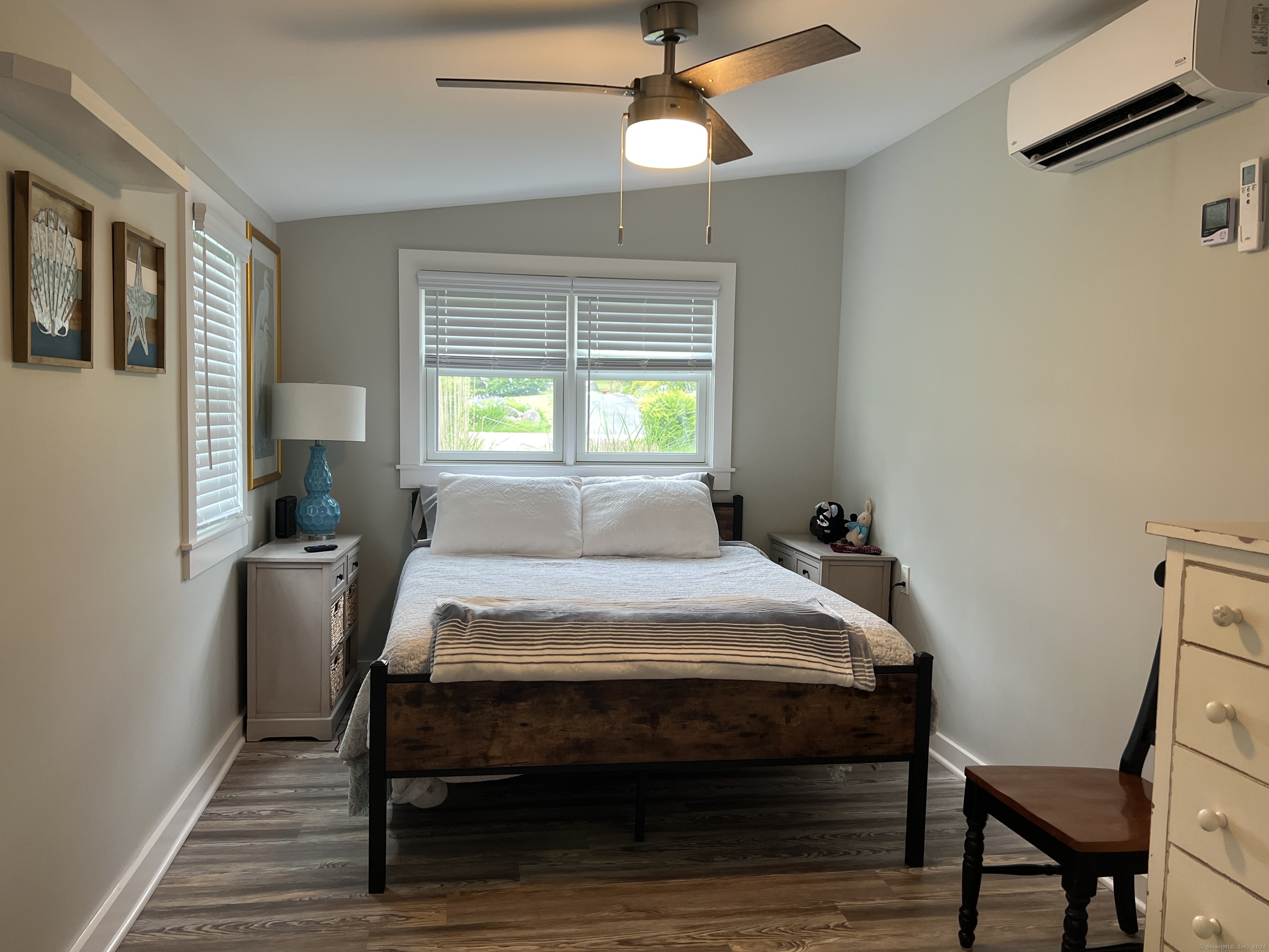 61 Old Black Point Road East Lyme, CT 06357 - Photo 13 of 27 a bed sitting in a bedroom next to a window