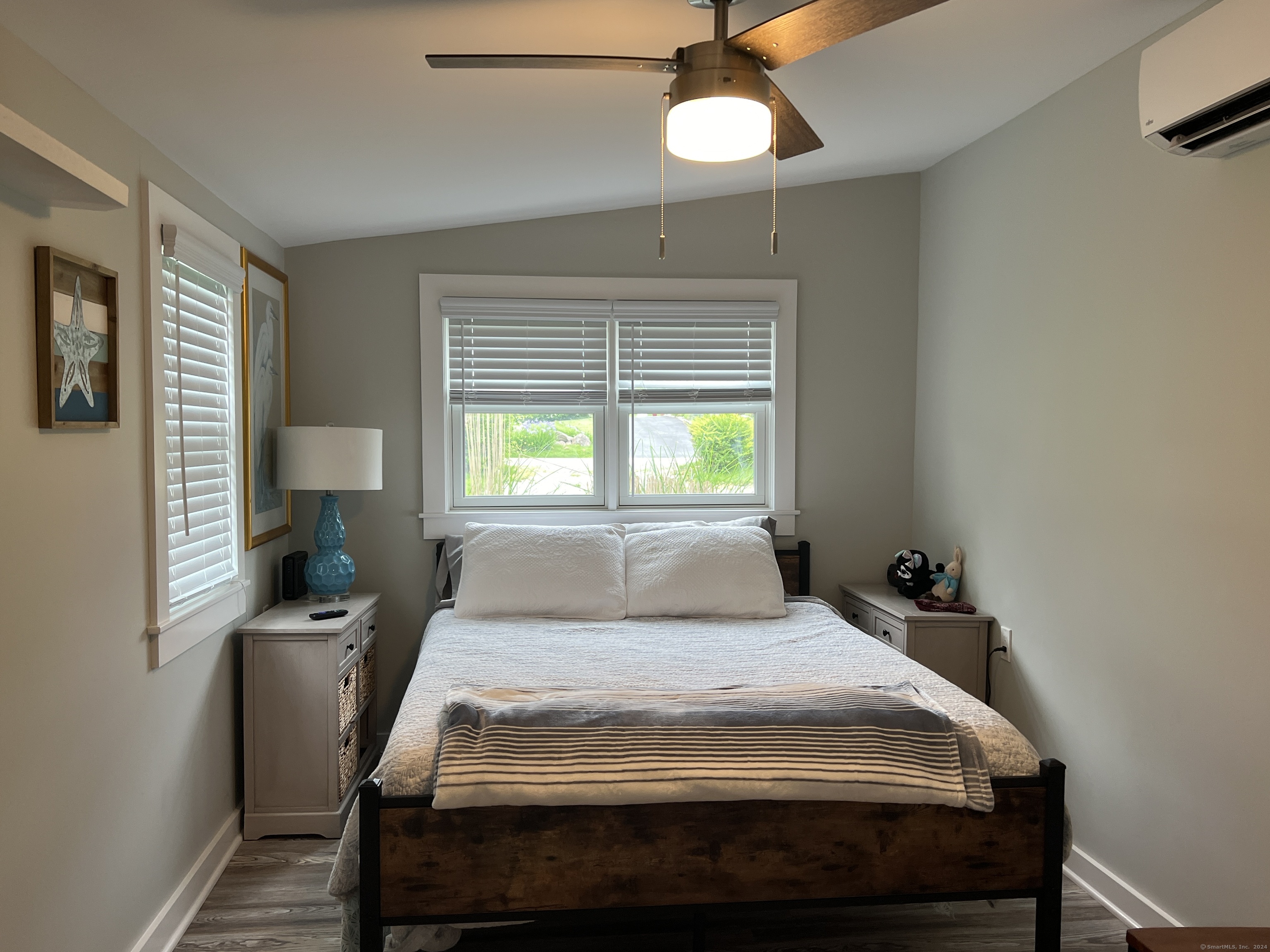 61 Old Black Point Road East Lyme, CT 06357 - Photo 14 of 27 a bedroom with a bed and a window