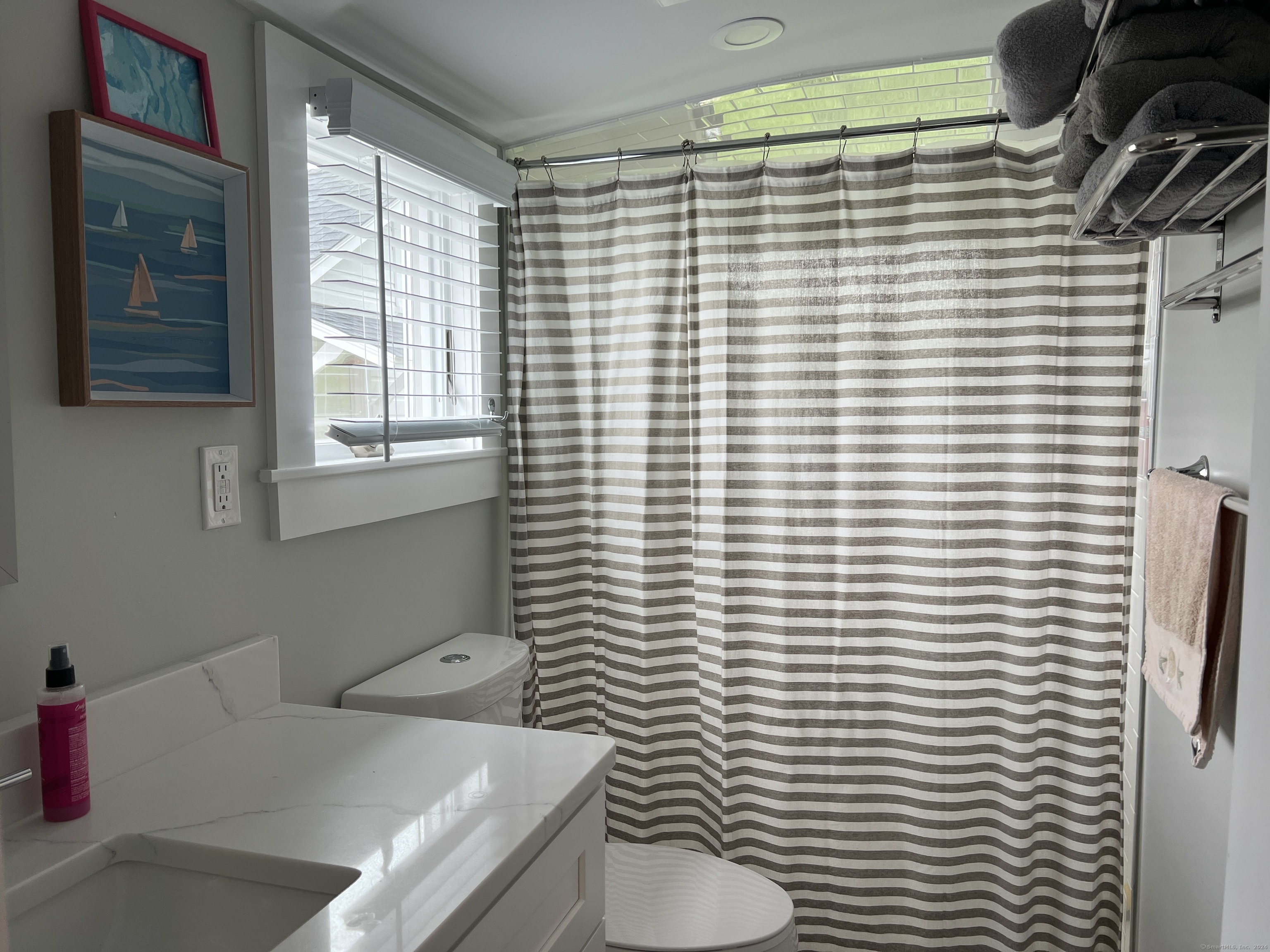 61 Old Black Point Road East Lyme, CT 06357 - Photo 15 of 27 a bathroom with a sink a toilet and shower curtain