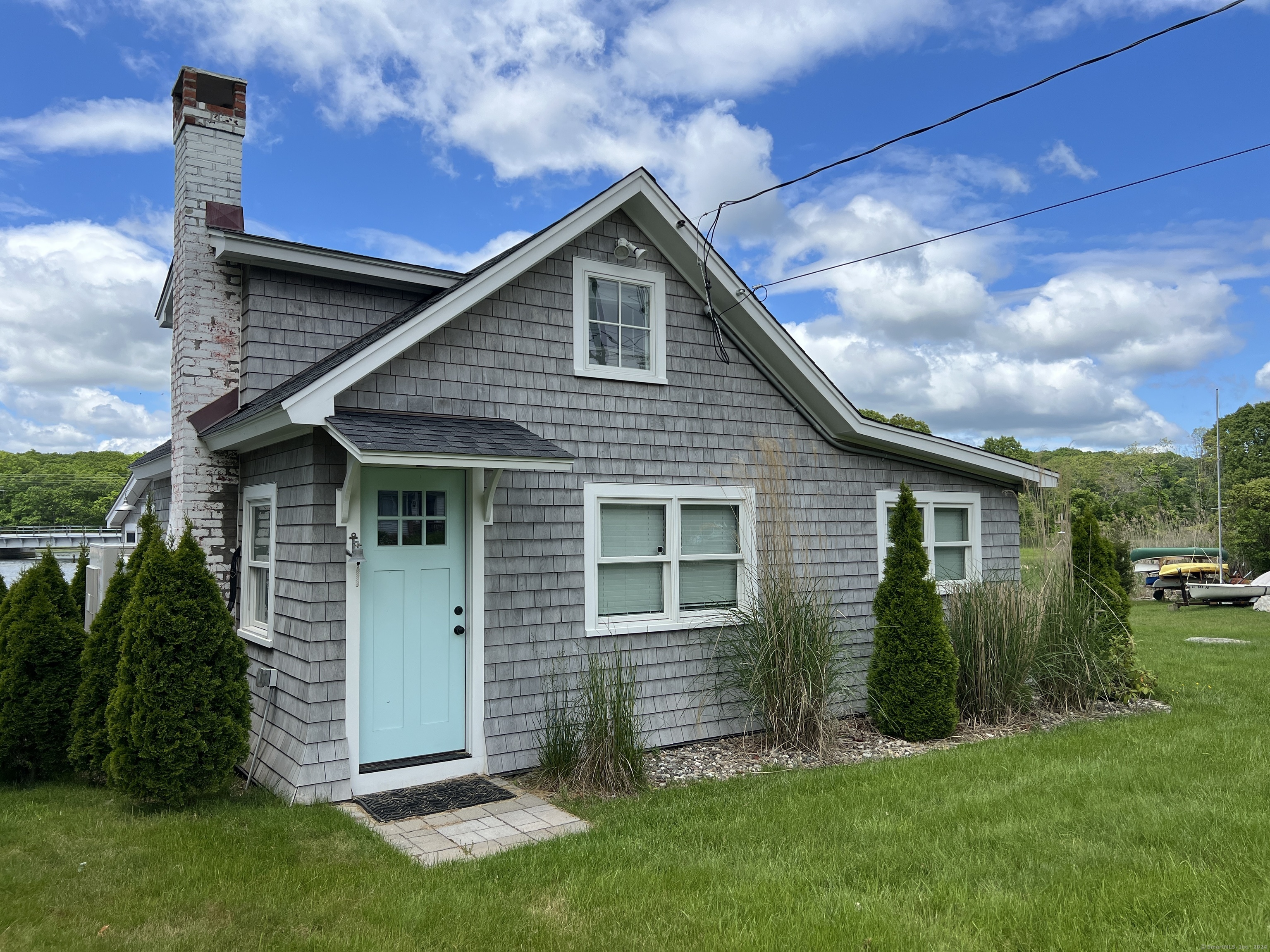 61 Old Black Point Road East Lyme, CT 06357 - Photo 2 of 27 a front view of house with a garden