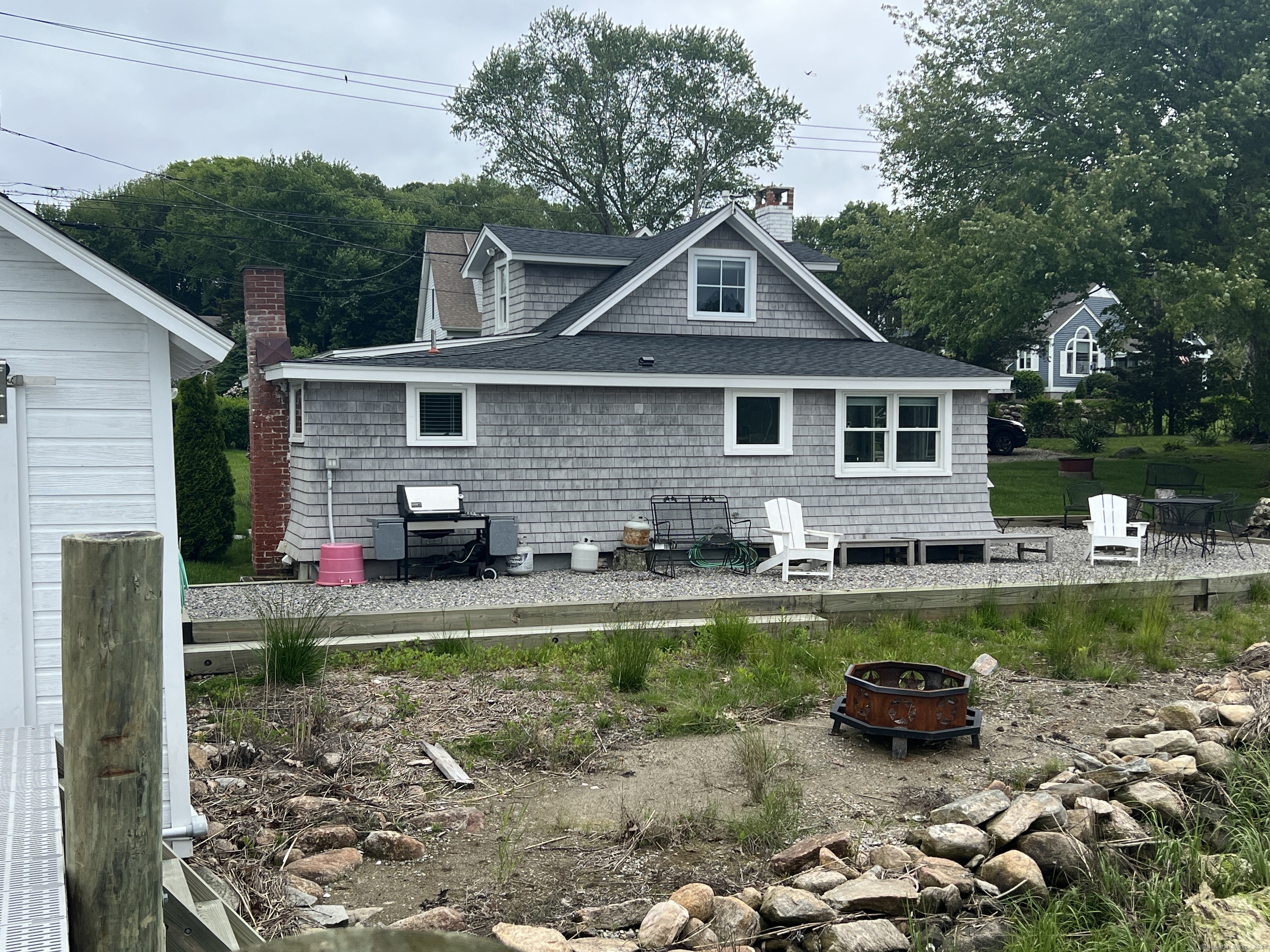 61 Old Black Point Road East Lyme, CT 06357 - Photo 26 of 27 a front view of a house with a yard