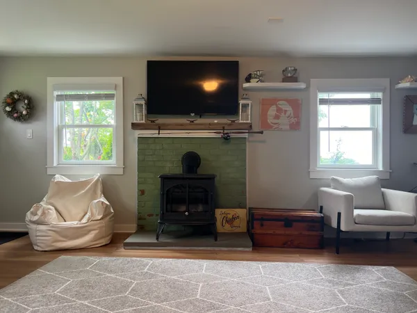 a living room with furniture a flat screen tv and a fireplace