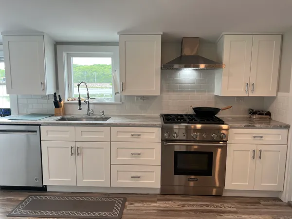 a kitchen with granite countertop a stove a sink and a granite counter tops