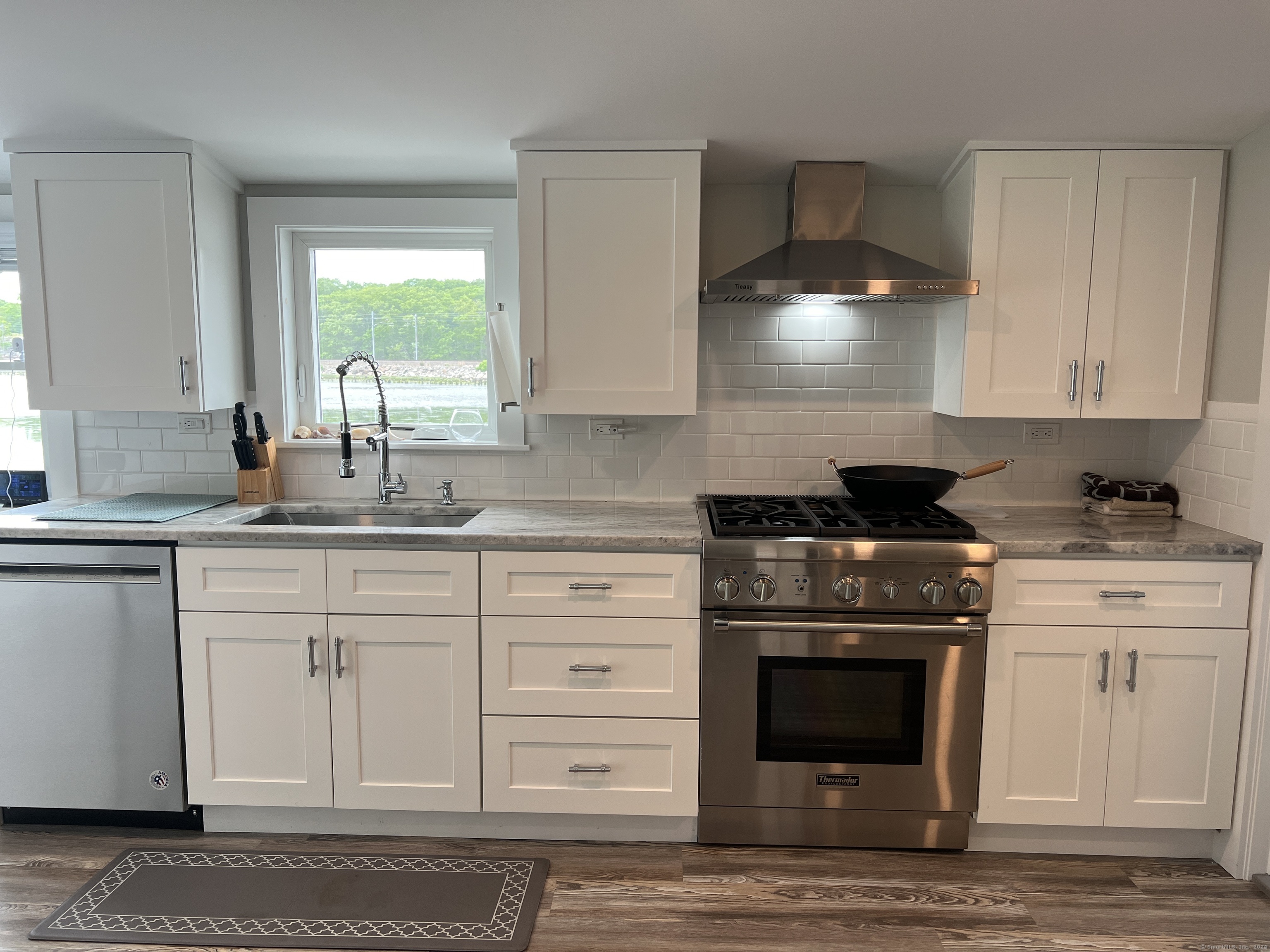 61 Old Black Point Road East Lyme, CT 06357 - Photo 8 of 27 a kitchen with granite countertop a stove a sink and a granite counter tops
