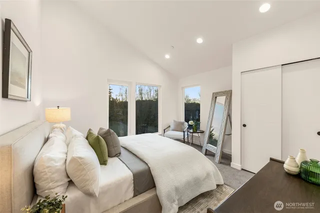 a bedroom with a bed and a large mirror with the potted plant