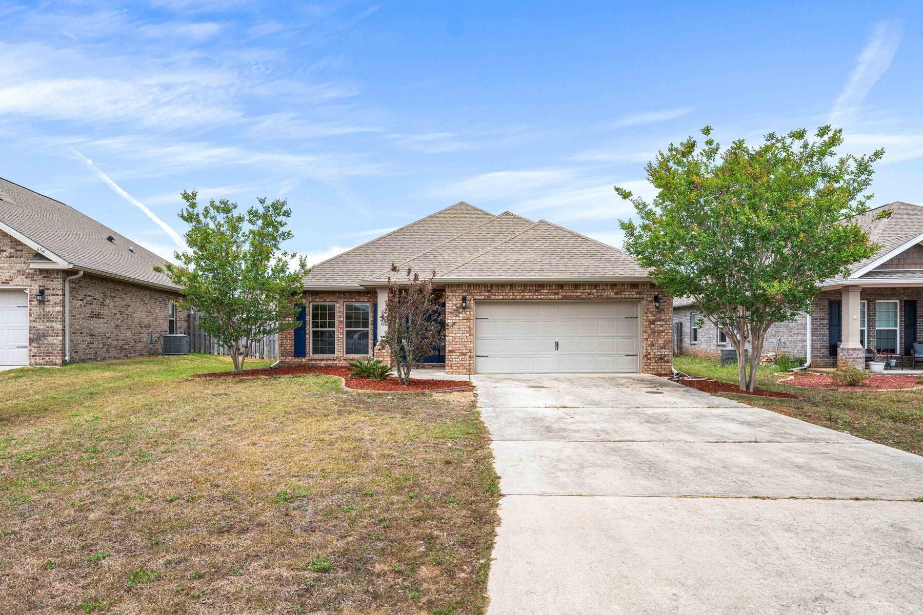 656 Teal Street Crestview, FL 32539 - Photo 18 of 58 a front view of a house with yard
