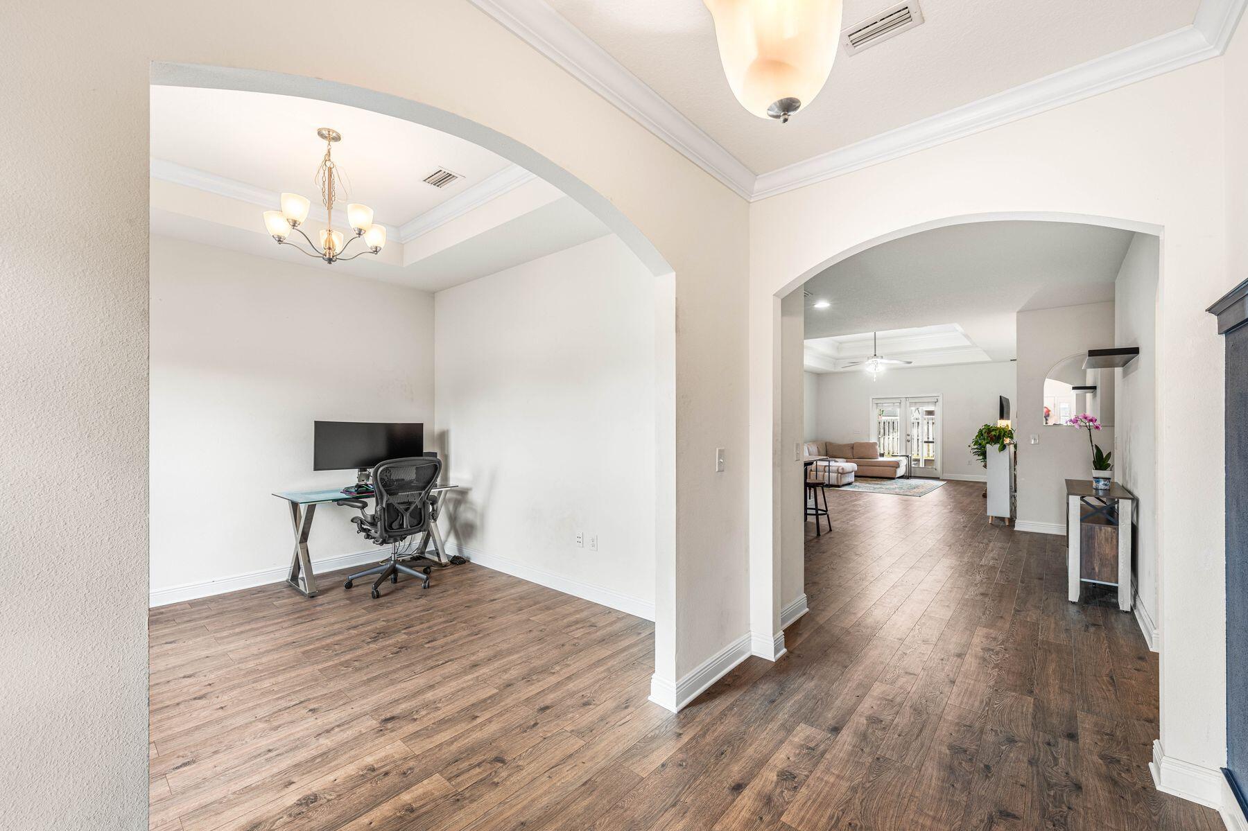 656 Teal Street Crestview, FL 32539 - Photo 20 of 58 a view of a livingroom with a furniture hardwood floor and a chandelier
