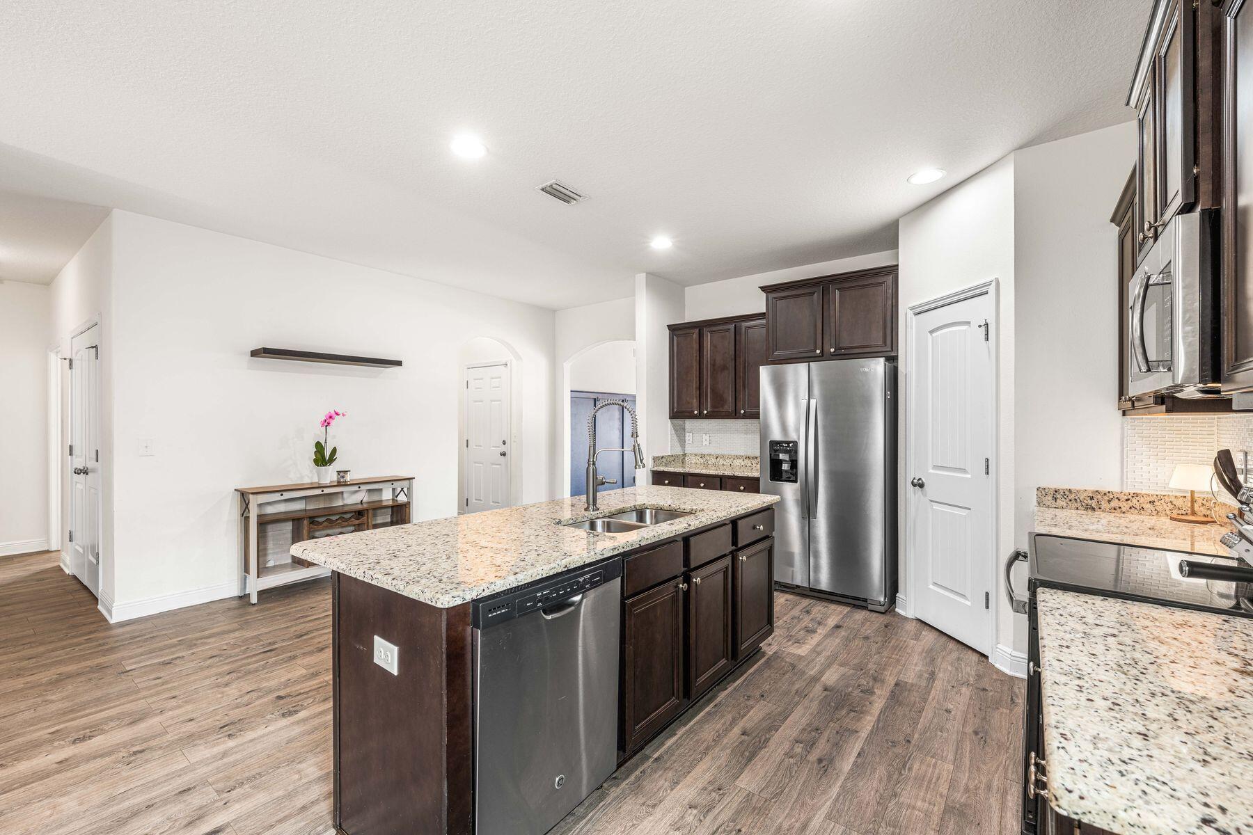 656 Teal Street Crestview, FL 32539 - Photo 22 of 58 a kitchen with stainless steel appliances granite countertop a stove refrigerator and a sink