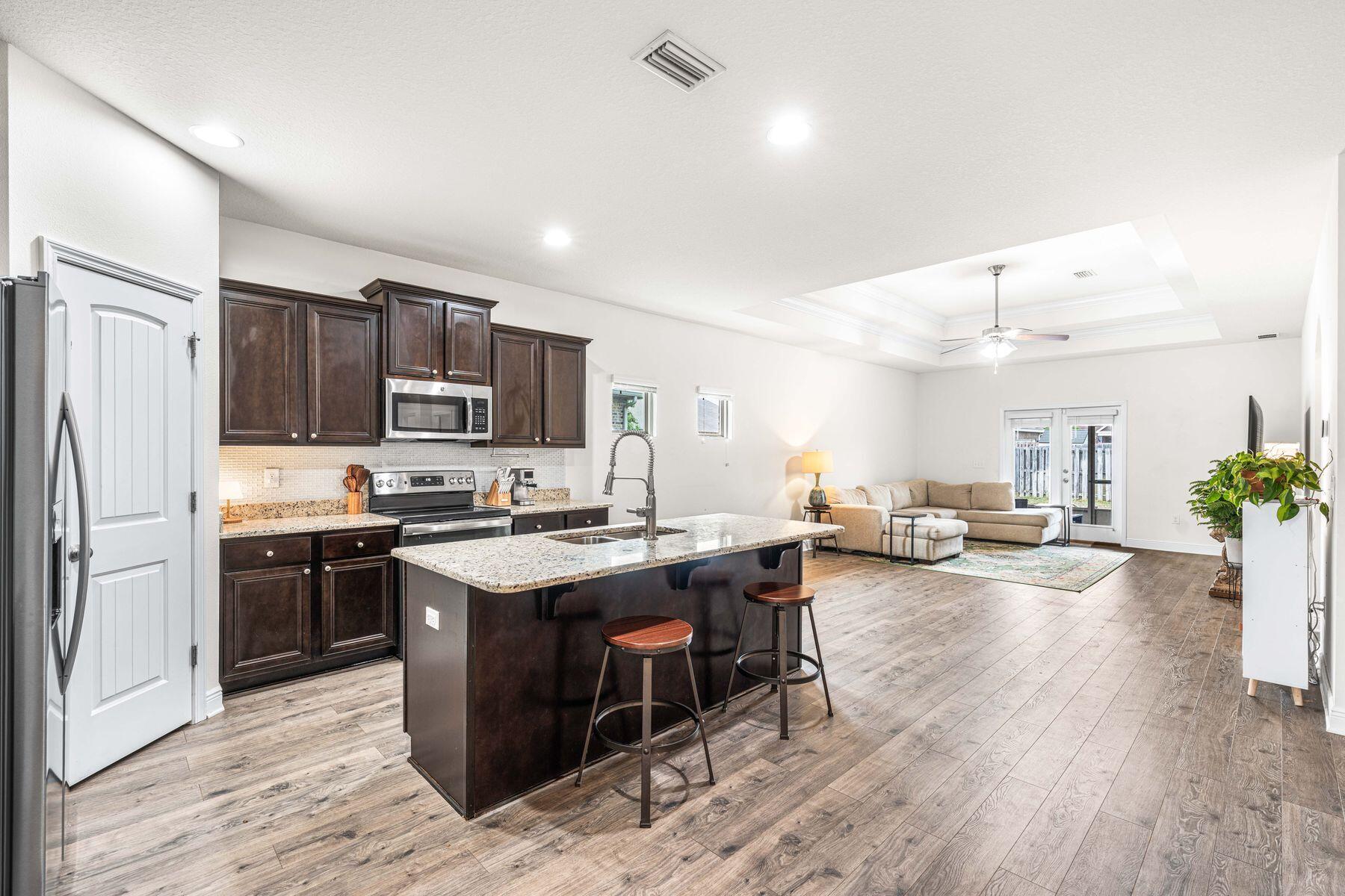 656 Teal Street Crestview, FL 32539 - Photo 23 of 58 a kitchen with sink a refrigerator and chairs