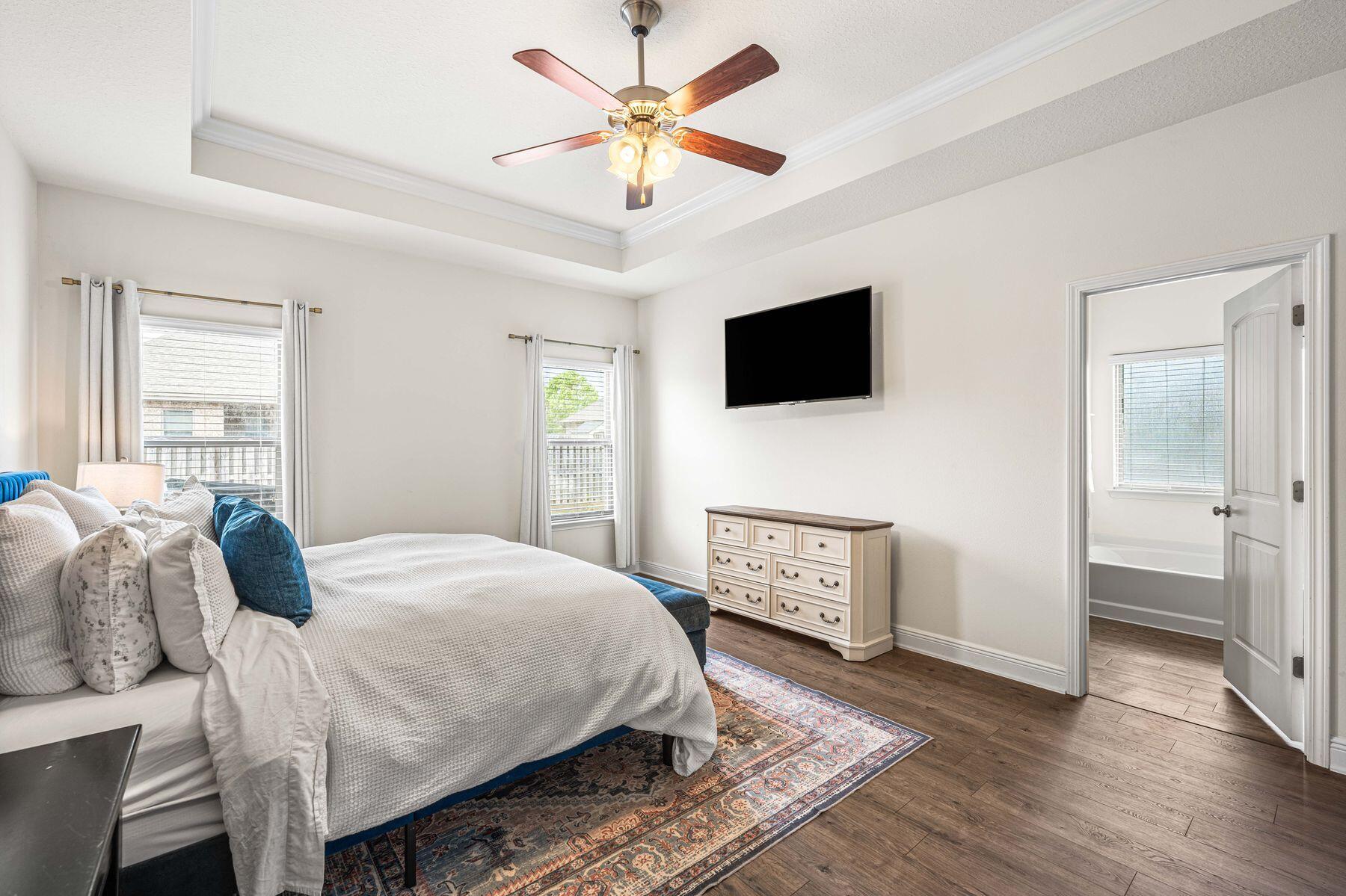656 Teal Street Crestview, FL 32539 - Photo 29 of 58 a bedroom with a bed and a flat screen tv