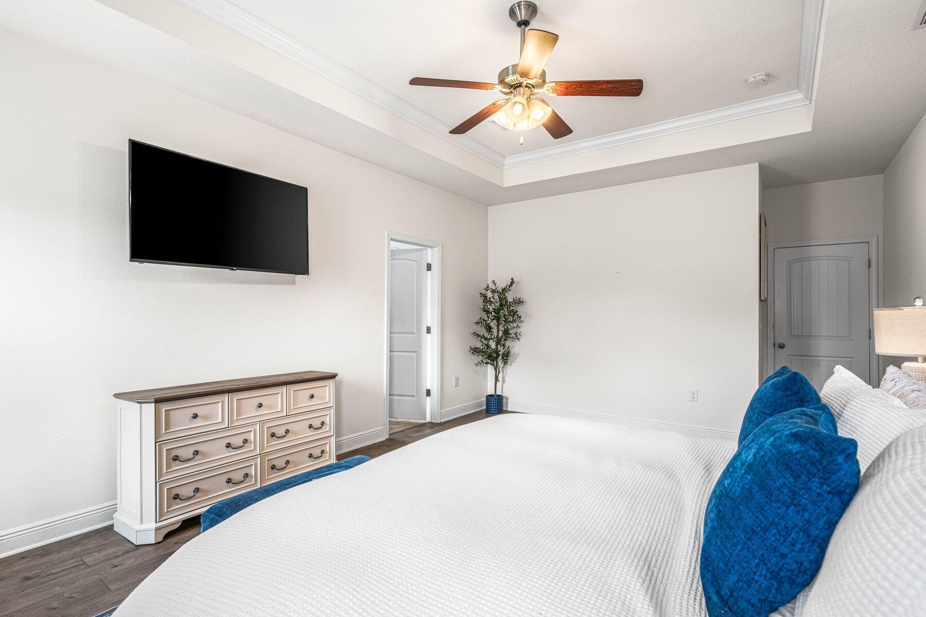 656 Teal Street Crestview, FL 32539 - Photo 30 of 58 a bedroom with a bed a flat screen tv and a couch