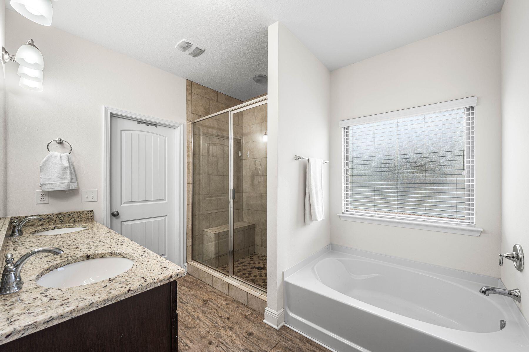 656 Teal Street Crestview, FL 32539 - Photo 31 of 58 a bathroom with a granite countertop sink and a bathtub