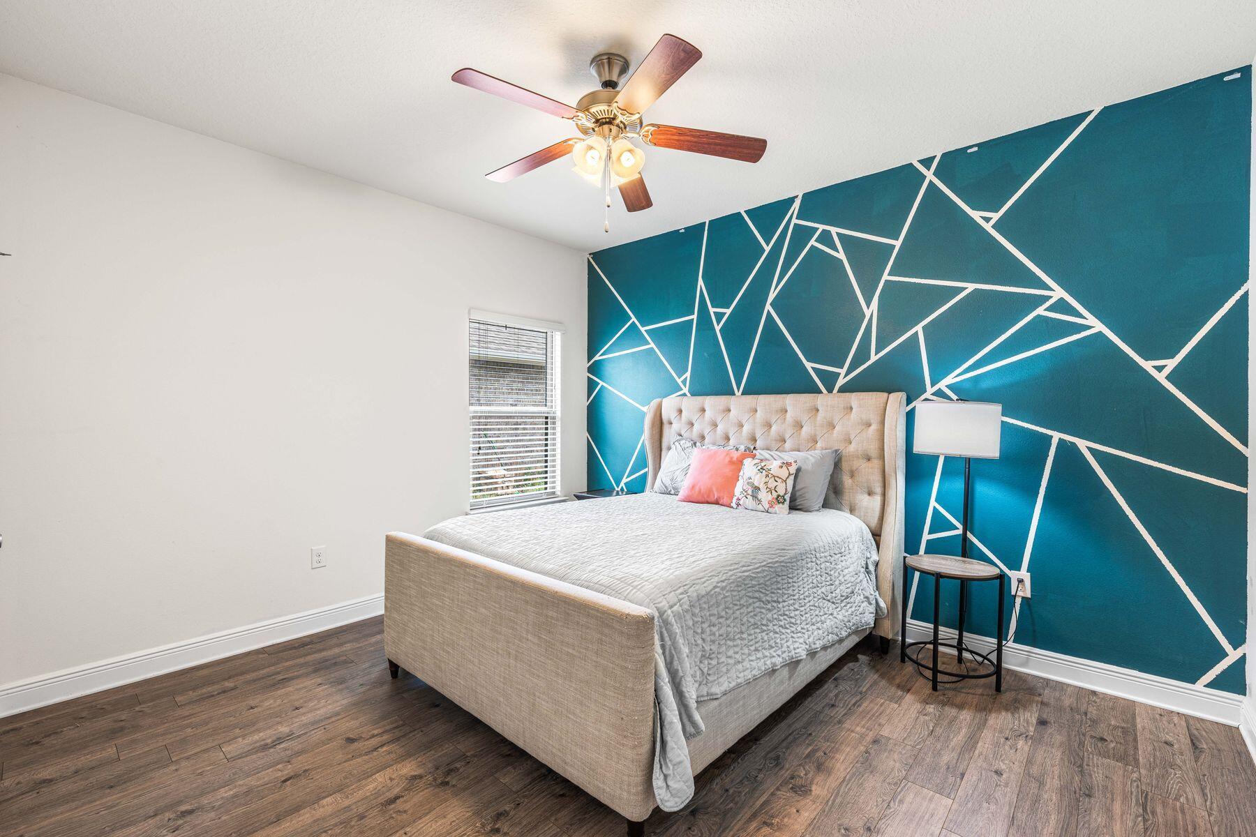 656 Teal Street Crestview, FL 32539 - Photo 32 of 58 a bedroom with a bed and a ceiling fan