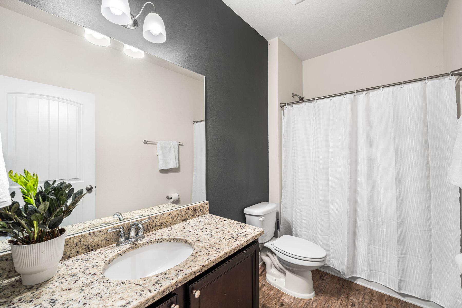 656 Teal Street Crestview, FL 32539 - Photo 34 of 58 a bathroom with a granite countertop sink toilet and a mirror