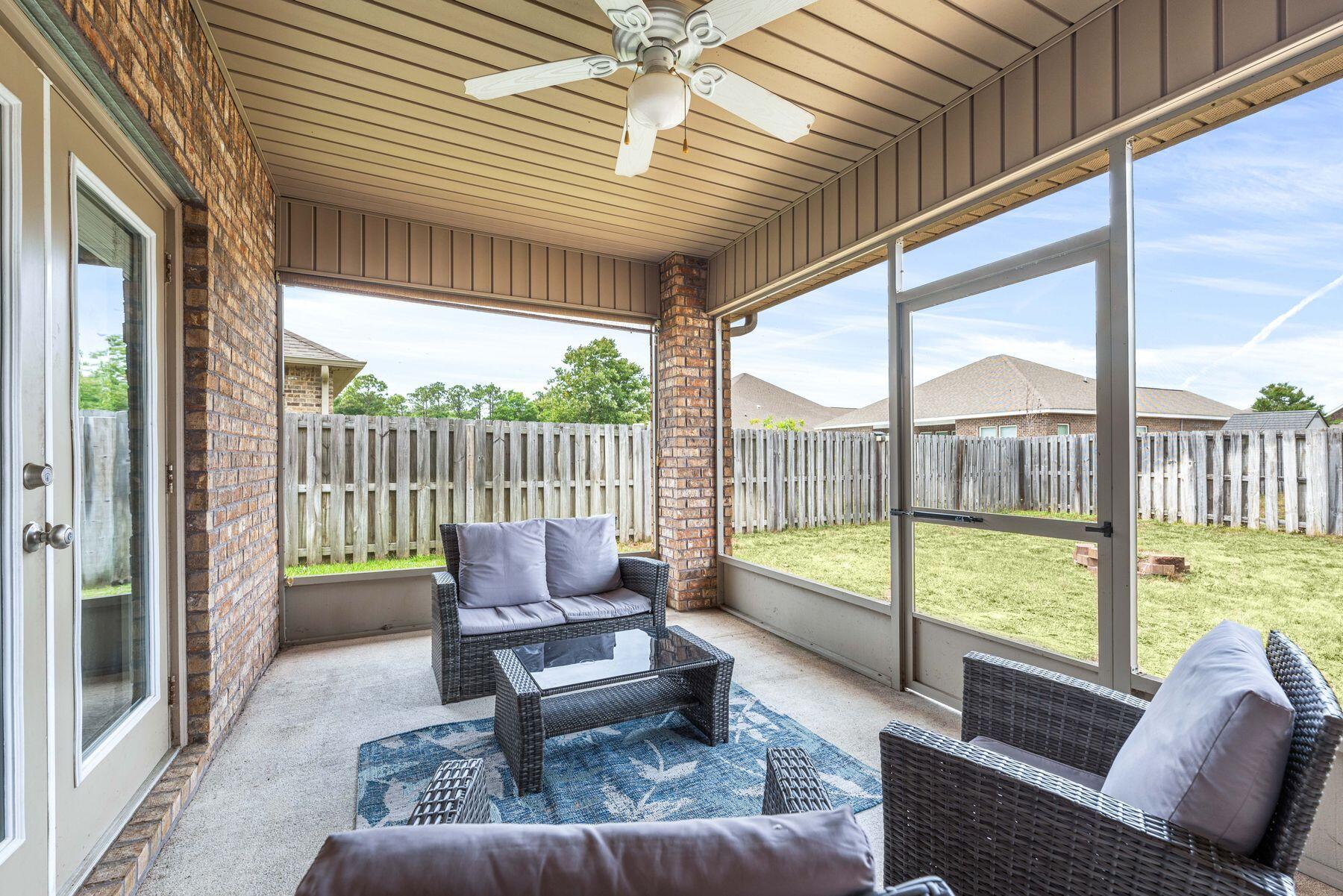 656 Teal Street Crestview, FL 32539 - Photo 40 of 58 a balcony with furniture and a garden