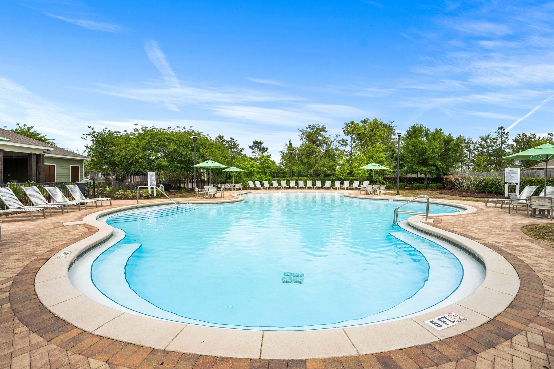 656 Teal Street Crestview, FL 32539 - Photo 43 of 58 a view of a swimming pool with an outdoor seating