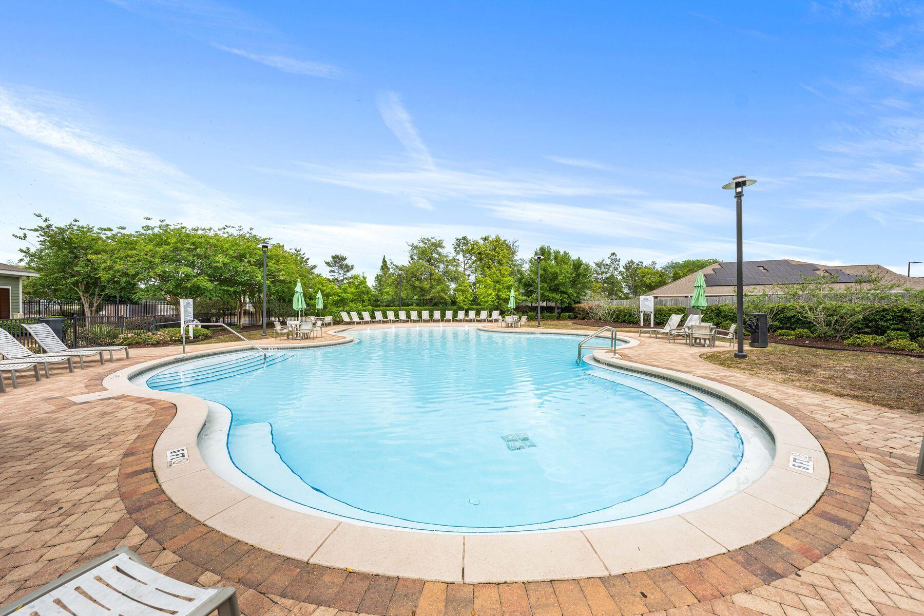 656 Teal Street Crestview, FL 32539 - Photo 44 of 58 a view of a swimming pool with a yard