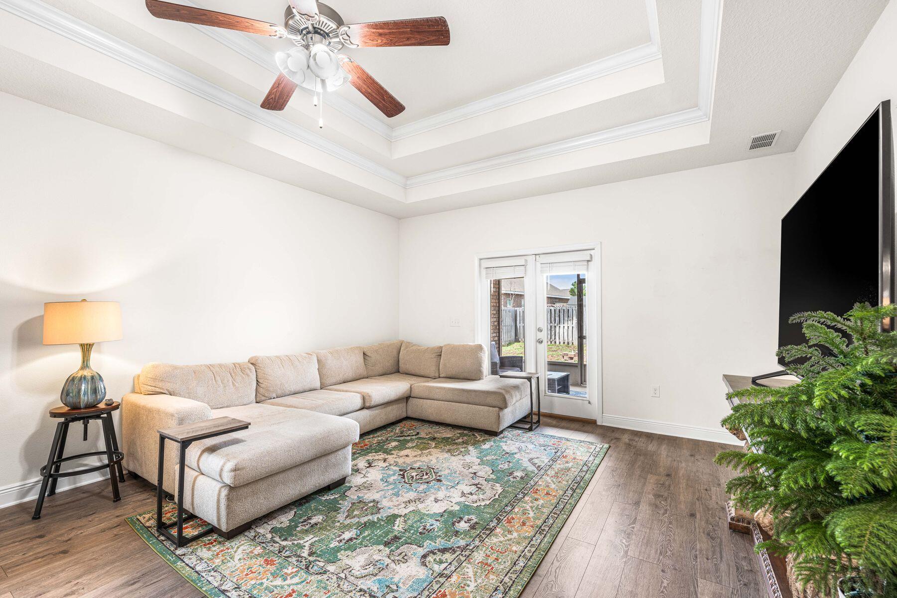 656 Teal Street Crestview, FL 32539 - Photo 7 of 58 a living room with furniture and a flat screen tv