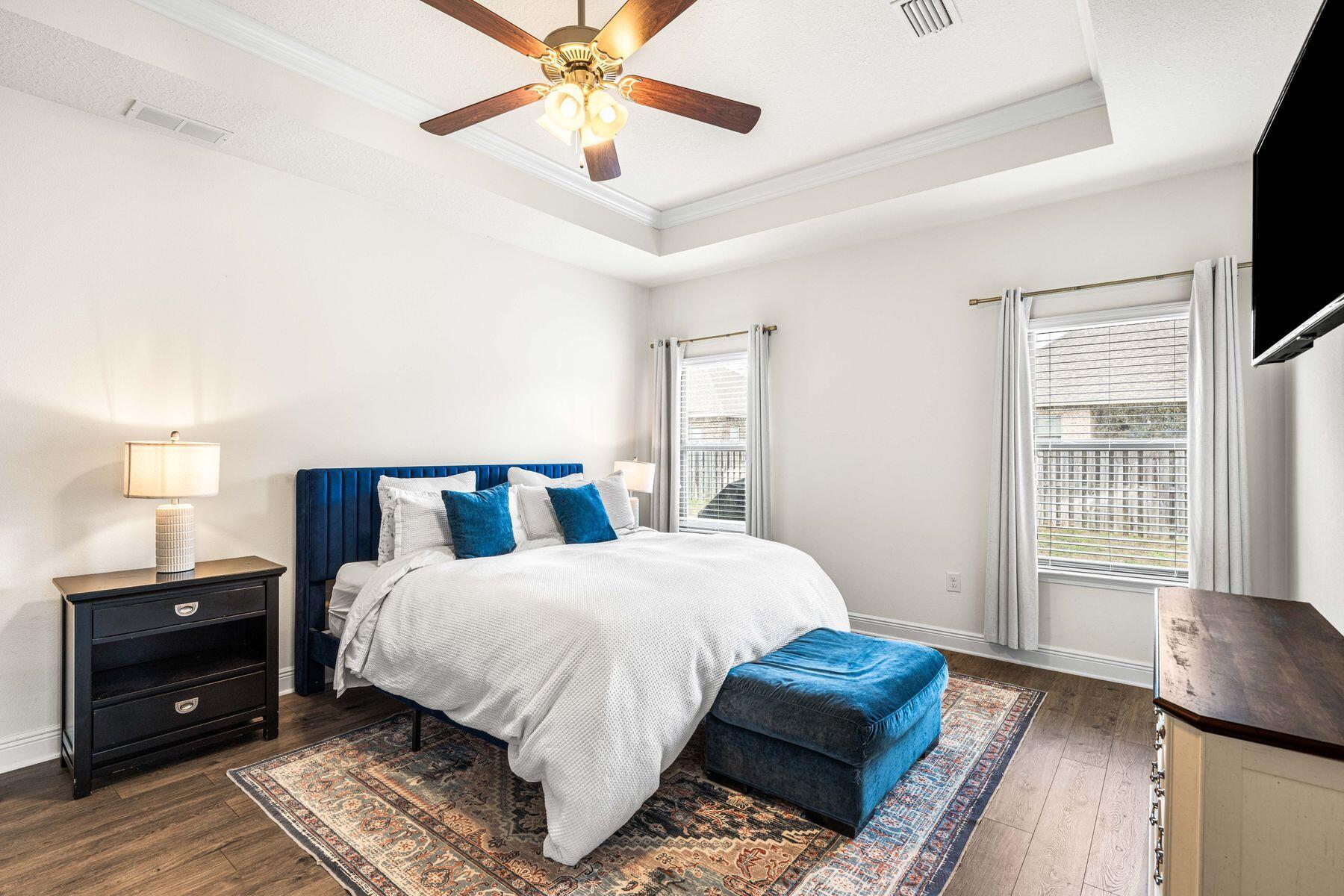 656 Teal Street Crestview, FL 32539 - Photo 8 of 58 a bedroom with a bed chandelier and a window