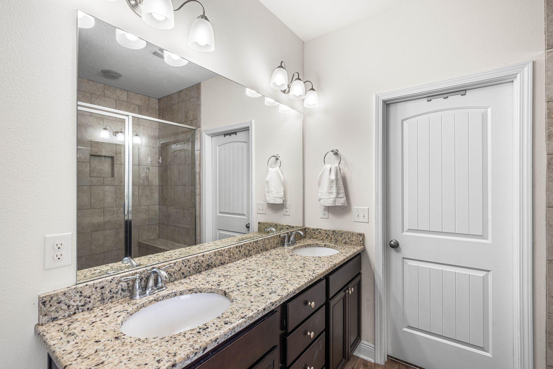 656 Teal Street Crestview, FL 32539 - Photo 9 of 58 a bathroom with a granite countertop sink a light fixture and a mirror