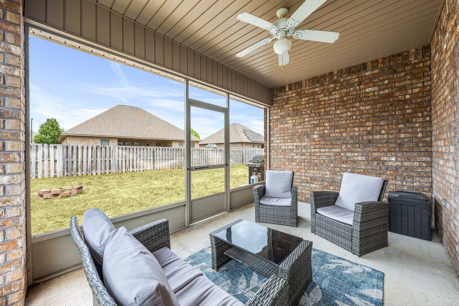 656 Teal Street Crestview, FL 32539 - Photo 10 of 58 a living room with furniture and a floor to ceiling window