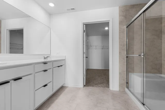 a bathroom with a double vanity sink and mirror