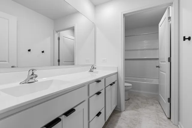 a bathroom with a sink double vanity and a mirror