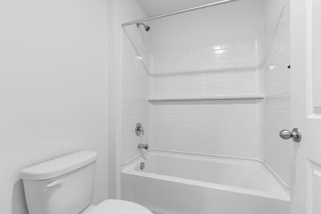 a bathroom with a shower and a toilet