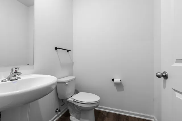 a bathroom with a sink toilet and a mirror