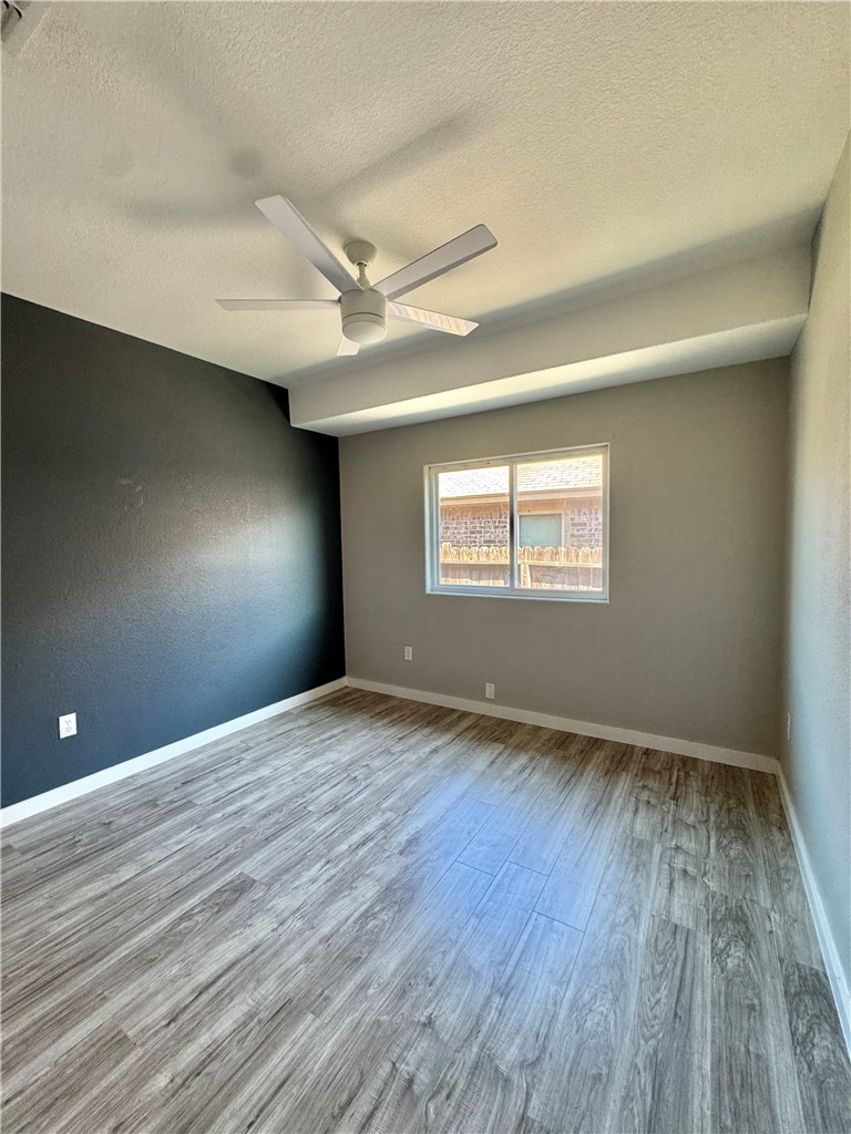 322 Pacific Drive Portland, TX 78374 - Photo 17 of 22 an empty room with wooden floor and windows