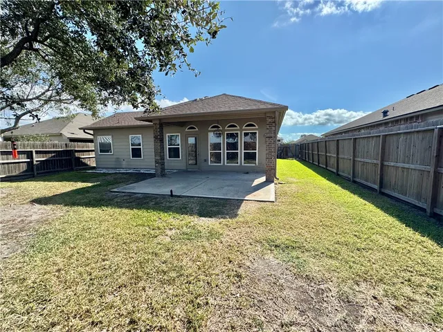 a view of a house with pool and a yard