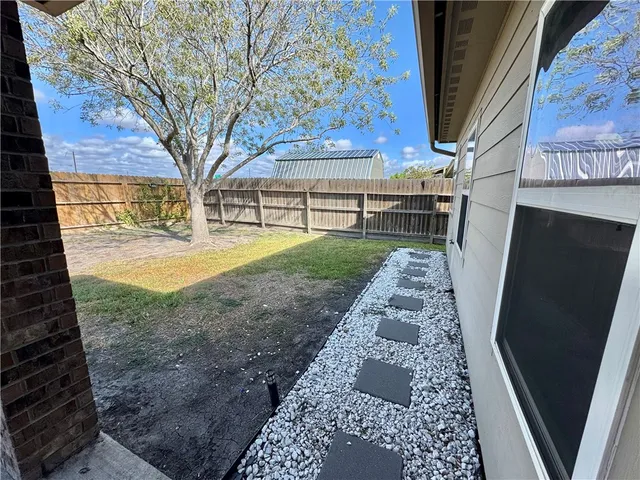 a view of a backyard with pathway