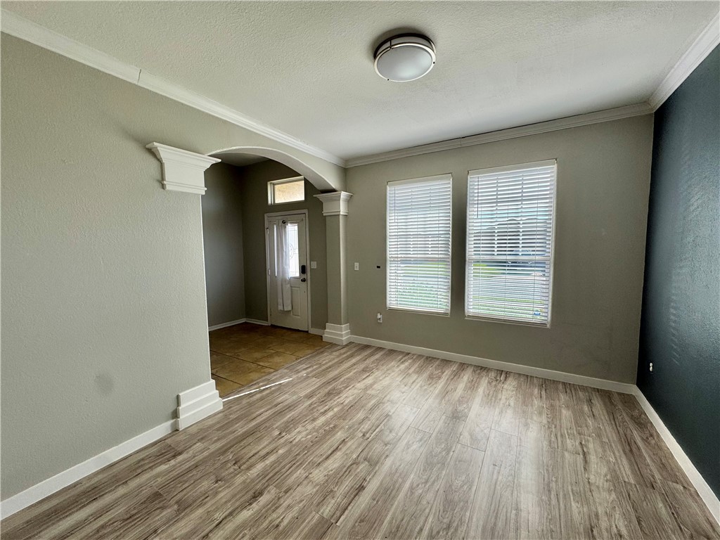 322 Pacific Drive Portland, TX 78374 - Photo 3 of 22 an empty room with wooden floor and windows