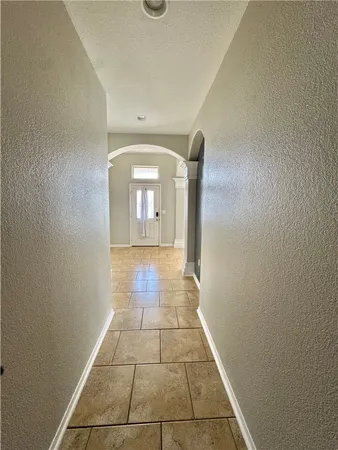 a view of a livingroom with wooden floor and a hallway