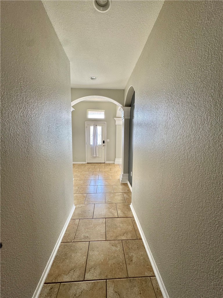 322 Pacific Drive Portland, TX 78374 - Photo 5 of 22 a view of a livingroom with wooden floor and a hallway
