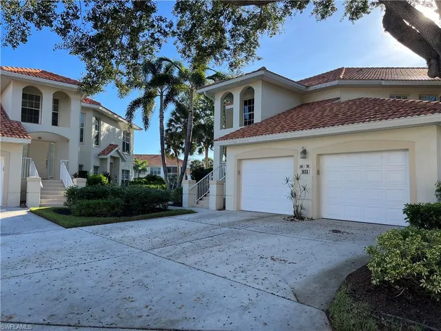 a front view of a house with a garden and garage
