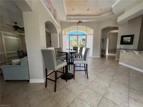 a dining room with furniture and a window