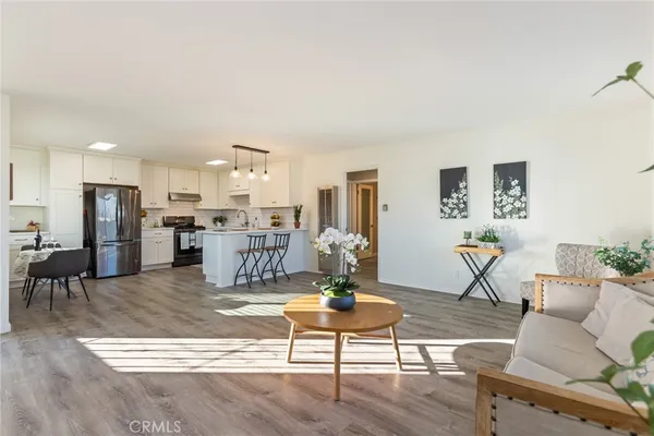 a living room with furniture and kitchen view