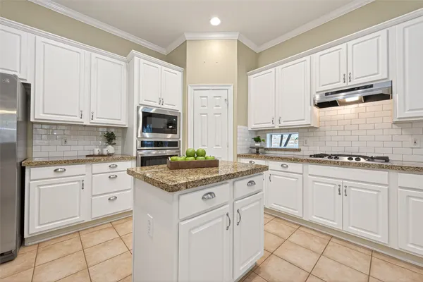a kitchen with cabinets stainless steel appliances a sink and a counter space