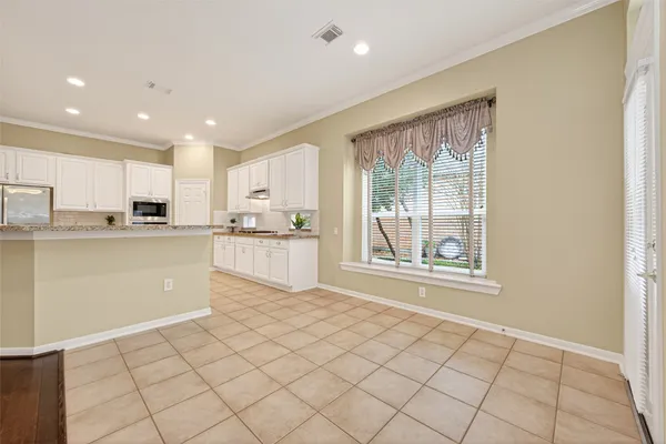 a kitchen with stainless steel appliances granite countertop a refrigerator sink and cabinets