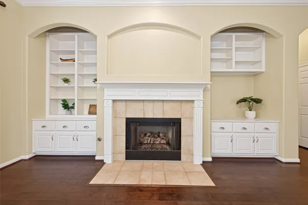 a living room with cabinets and a fireplace