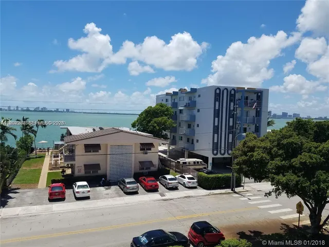 a view of a parking space with lots of car parked in front of it