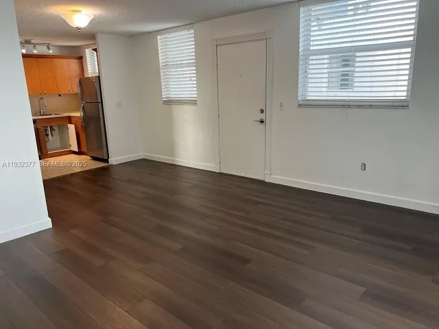 a view of a parking space with lots of car parked in front of it