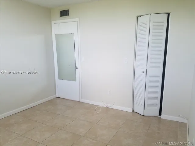 an empty room with closet area
