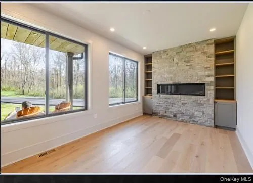 a living room with fireplace furniture and a large window