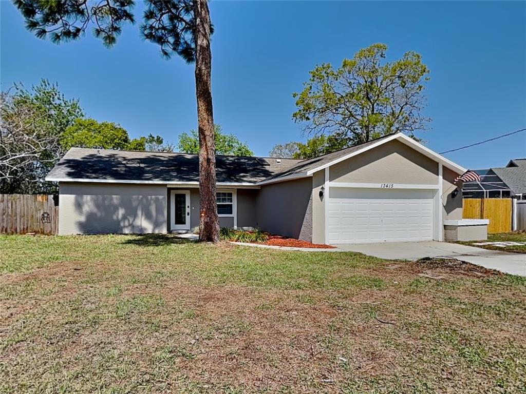 Undisclosed Address Spring Hill, FL 34609 - Photo 1 of 1 a view of a house with a yard and a tree