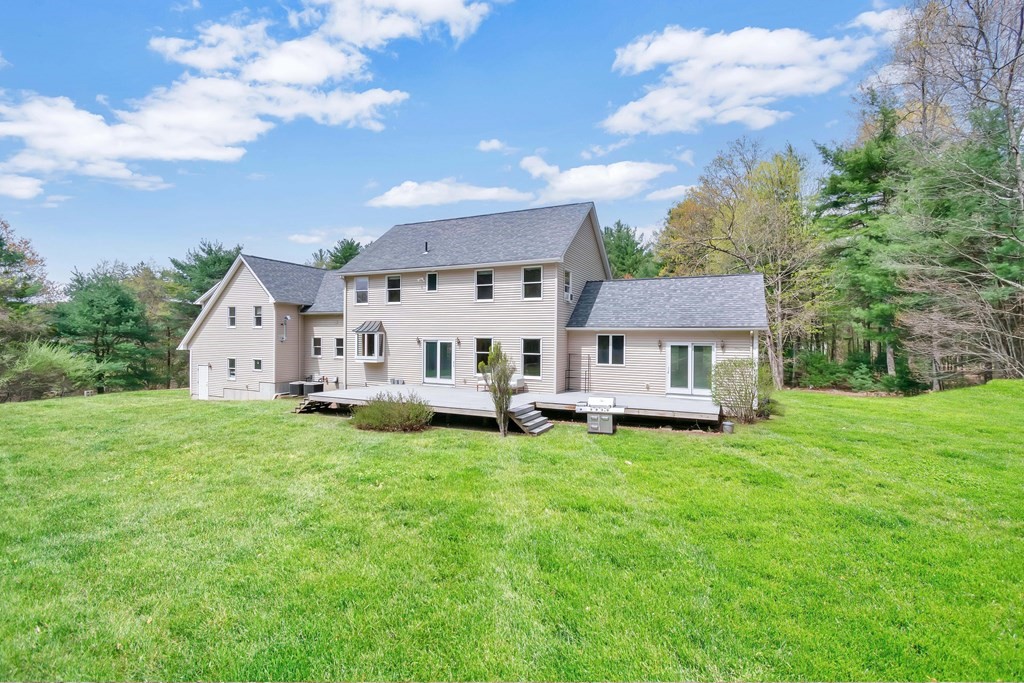 11 Maxwell Road Monson, MA 01057 - Photo 36 of 41 a white house that has a big yard and a big trees with wooden fence