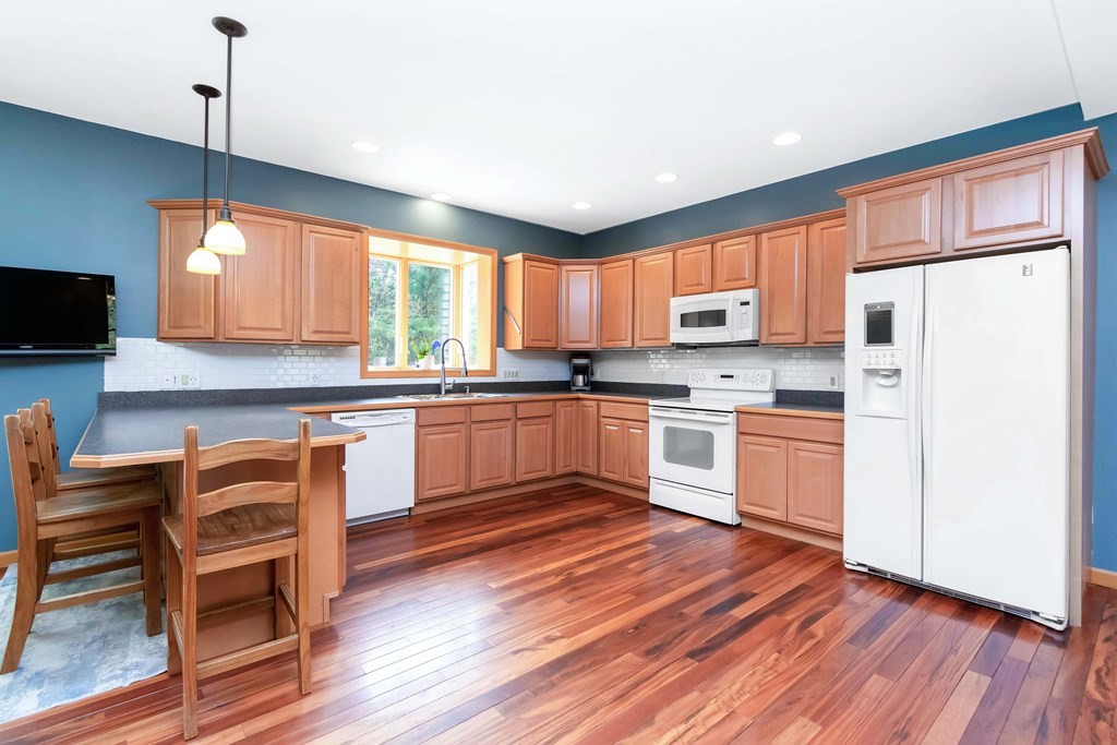 11 Maxwell Road Monson, MA 01057 - Photo 6 of 41 a kitchen with a refrigerator cabinets and wooden floor