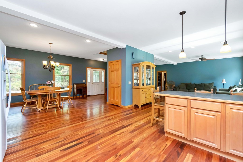 11 Maxwell Road Monson, MA 01057 - Photo 9 of 41 a open kitchen with stainless steel appliances granite countertop a refrigerator a sink dishwasher a dining table and chairs with wooden floor