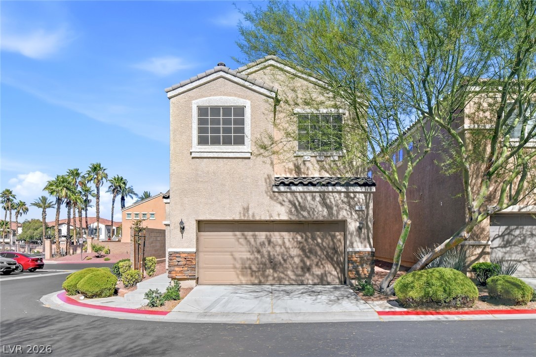 48 Jasmine Point Street Henderson, NV 89074 - Photo 57 of 62 A desert oasis home, framed by lush greenery, offers a private garage.
